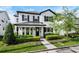 Beautiful two-story home with classic white siding, black shutters, and a neatly landscaped front yard at 1414 W New Hampshire St, Orlando, FL 32804
