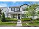 Charming two-story home featuring black accents, manicured landscaping, and a welcoming brick walkway at 1414 W New Hampshire St, Orlando, FL 32804