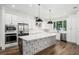 Stylish kitchen featuring stainless steel appliances, white cabinets, and a center island with designer details at 1414 W New Hampshire St, Orlando, FL 32804