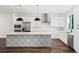 Modern kitchen with stainless steel appliances, white cabinetry, and a unique patterned kitchen island at 1414 W New Hampshire St, Orlando, FL 32804