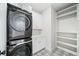 A modern laundry room with stacked washer/dryer and built-in cabinets at 1414 W New Hampshire St, Orlando, FL 32804