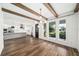 Open concept living and dining area with beautiful wood floors, exposed beams, and lots of natural light at 1414 W New Hampshire St, Orlando, FL 32804