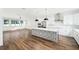 Open-concept living space featuring wood floors, modern lighting, and a seamless transition to the kitchen at 1414 W New Hampshire St, Orlando, FL 32804