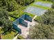 Aerial view of the community racquetball court, basketball courts, and serene, tree-lined surroundings at 14306 Paradise Tree Dr, Orlando, FL 32828