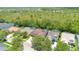 An elevated neighborhood view showcases a home with a screened-in pool, near lush woods and a community landscape at 14306 Paradise Tree Dr, Orlando, FL 32828