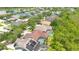 Aerial view showcases a residential neighborhood with various home styles and well-kept yards near a lake at 14306 Paradise Tree Dr, Orlando, FL 32828