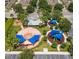 Aerial view of a well-maintained playground with multiple play areas, shaded structures, and landscaped surroundings at 14306 Paradise Tree Dr, Orlando, FL 32828