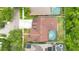 Aerial view of a home with a backyard pool and a well-maintained roof in a suburban neighborhood at 14306 Paradise Tree Dr, Orlando, FL 32828