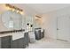 Bathroom with dual sinks, modern fixtures, vanity, and glass block window for natural light at 14306 Paradise Tree Dr, Orlando, FL 32828