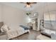 Comfortable bedroom featuring a desk, vanity, and a hanging chair in addition to a bed and other decorations at 14306 Paradise Tree Dr, Orlando, FL 32828