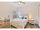 Bright bedroom featuring a comfortable bed with bedside tables and storage shelves with a window that provides natural light at 14306 Paradise Tree Dr, Orlando, FL 32828
