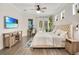 Comfortable bedroom with a bed, hardwood floors, and a view of the backyard at 14306 Paradise Tree Dr, Orlando, FL 32828
