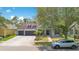 Charming home with three-car garage, well-kept lawn, and attractive landscaping, enhanced by a mature shade tree at 14306 Paradise Tree Dr, Orlando, FL 32828