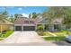 Charming home with a three-car garage, well-manicured lawn, and appealing curb appeal in a sunny neighborhood at 14306 Paradise Tree Dr, Orlando, FL 32828
