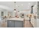 Modern kitchen with white cabinets, a gray island, stainless steel appliances, and pendant lighting at 14306 Paradise Tree Dr, Orlando, FL 32828