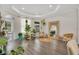 Spacious living room featuring hardwood floors, many plants, and natural light at 14306 Paradise Tree Dr, Orlando, FL 32828