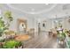 Open-concept living room with hardwood floors, large mirror, and plenty of natural light at 14306 Paradise Tree Dr, Orlando, FL 32828