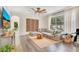 Cozy living room with hardwood floors, large sofa, and natural light streaming through the windows at 14306 Paradise Tree Dr, Orlando, FL 32828