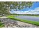 Scenic community walking path along the pond with lush greenery, offering a serene outdoor experience at 14306 Paradise Tree Dr, Orlando, FL 32828