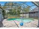 Inviting in-ground pool with a screened enclosure, surrounded by a paved patio and lush landscaping for privacy at 14306 Paradise Tree Dr, Orlando, FL 32828