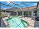 Beautiful pool with screened enclosure, offering a relaxing backyard oasis with a patio and lush landscaping and a volleyball net at 14306 Paradise Tree Dr, Orlando, FL 32828