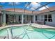 Beautiful swimming pool surrounded by a screened-in enclosure, and lovely patio area perfect for entertaining and a volleyball net at 14306 Paradise Tree Dr, Orlando, FL 32828