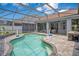 Relaxing screened-in pool with brick pavers and a lovely backyard view offers a space for leisure and enjoyment at 14306 Paradise Tree Dr, Orlando, FL 32828