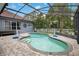 Enjoy the Florida sun in this refreshing screened-in pool with a volleyball net for outdoor fun and entertainment at 14306 Paradise Tree Dr, Orlando, FL 32828