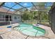 Backyard pool with screened enclosure, paved patio, and lush landscaping for a private outdoor oasis and a volleyball net at 14306 Paradise Tree Dr, Orlando, FL 32828