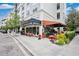 Charming outdoor seating at a stylish French cuisine restaurant with a covered awning and bright red chairs at 14306 Paradise Tree Dr, Orlando, FL 32828