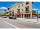 Street-side view of a commercial building with colorful awnings and parked cars on a sunny day at 14306 Paradise Tree Dr, Orlando, FL 32828