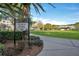 Entrance to a charming town park with lush greenery and scenic walking paths at 14306 Paradise Tree Dr, Orlando, FL 32828