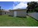 Side exterior of home next to a modern white fence in a grassy yard at 144 Mandrake St, Orlando, FL 32811