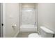 Bright bathroom featuring a tub-shower combo with elegant marble-like tile surround at 144 Mandrake St, Orlando, FL 32811