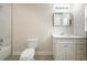 Bright bathroom featuring marble tiling and white cabinetry at 144 Mandrake St, Orlando, FL 32811
