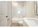 Bright bathroom featuring marble tiling in the shower and a light countertop at 144 Mandrake St, Orlando, FL 32811