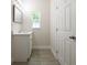 Bathroom featuring a vanity with a quartz countertop and wood-look tile flooring at 144 Mandrake St, Orlando, FL 32811