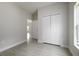 Empty bedroom with neutral walls, a large window, stylish flooring, and a closet creating a modern and inviting space at 144 Mandrake St, Orlando, FL 32811