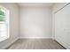 Bedroom with tiled floors, closet, and a large window at 144 Mandrake St, Orlando, FL 32811