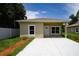 Tan single story home with a modern design, concrete driveway, and a well-maintained, landscaped yard at 144 Mandrake St, Orlando, FL 32811