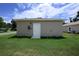 Exterior back view of home with well-maintained lawn and a serene setting at 144 Mandrake St, Orlando, FL 32811