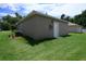 Exterior back of home featuring lush green grass and exterior unit at 144 Mandrake St, Orlando, FL 32811