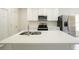 Kitchen island with stainless steel sink, stainless appliances, and ample counter space at 144 Mandrake St, Orlando, FL 32811