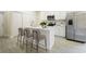 Modern white kitchen featuring an island, stainless steel appliances, and sleek countertops, perfect for cooking and entertaining at 144 Mandrake St, Orlando, FL 32811