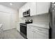 Kitchen with stainless steel appliances, white cabinets, and sleek countertops at 144 Mandrake St, Orlando, FL 32811