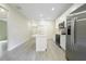 Well-lit kitchen featuring stainless steel appliances and a central island at 144 Mandrake St, Orlando, FL 32811