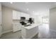Kitchen with a central island, stainless steel appliances, and white cabinetry at 144 Mandrake St, Orlando, FL 32811