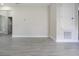Spacious room with wood-look tile flooring and access to other rooms at 144 Mandrake St, Orlando, FL 32811