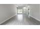 Open living area with wood-look tile flooring and ample natural light at 144 Mandrake St, Orlando, FL 32811