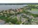 Stunning aerial view of waterfront community featuring luxurious homes with solar panels and lush landscaping at 15038 Masthead Landing Cir, Winter Garden, FL 34787